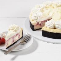 White Chocolate Raspberry Cheesecake · Cheesecake swirled with raspberries and pieces of white chocolate. Baked on a chocolate crum...