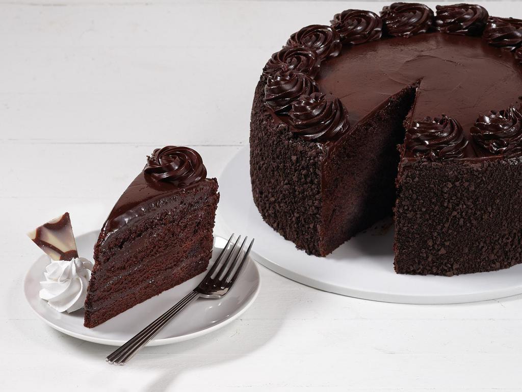 Fudge Cake · Moist fudge cake layered with rich chocolate fudge icing, finished with chocolate cream rosettes