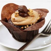 Peanut Butter Cup Cupcake · Rich, decadent, milk chocolate cake topped with creamy peanut butter icing. Garnished with a...