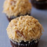German Chocolate Cupcake · A rich classic chocolate cupcake topped with peanut butter buttercream and garnished with cr...