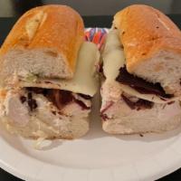 Empire State Sandwich · Smoked turkey, pepper mill turkey, cheddar cheese, and sweet peppers with coleslaw. Served w...