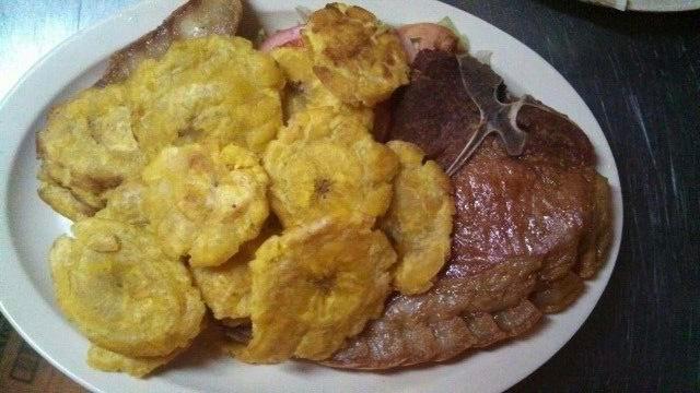 UNA)Chuletas con Tostones Lunch Special (ONE · Fried pork chops with fried plantains