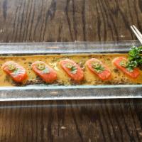Salmon Carpaccio · Served with radish sprouts and Aji-amarillo chili sauce.