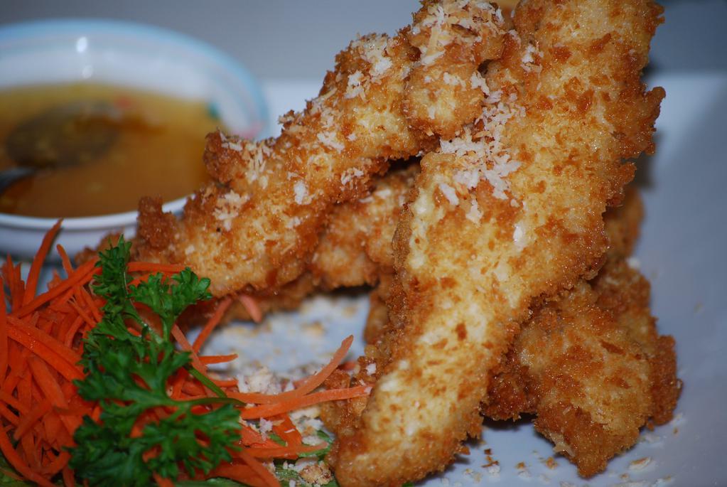 Coconut Chicken Finger · Tender sliced white chicken meat dipped in homemade coconut batter, coated with panko breadcrumb and fried until golden brown. Served with plum sauce.