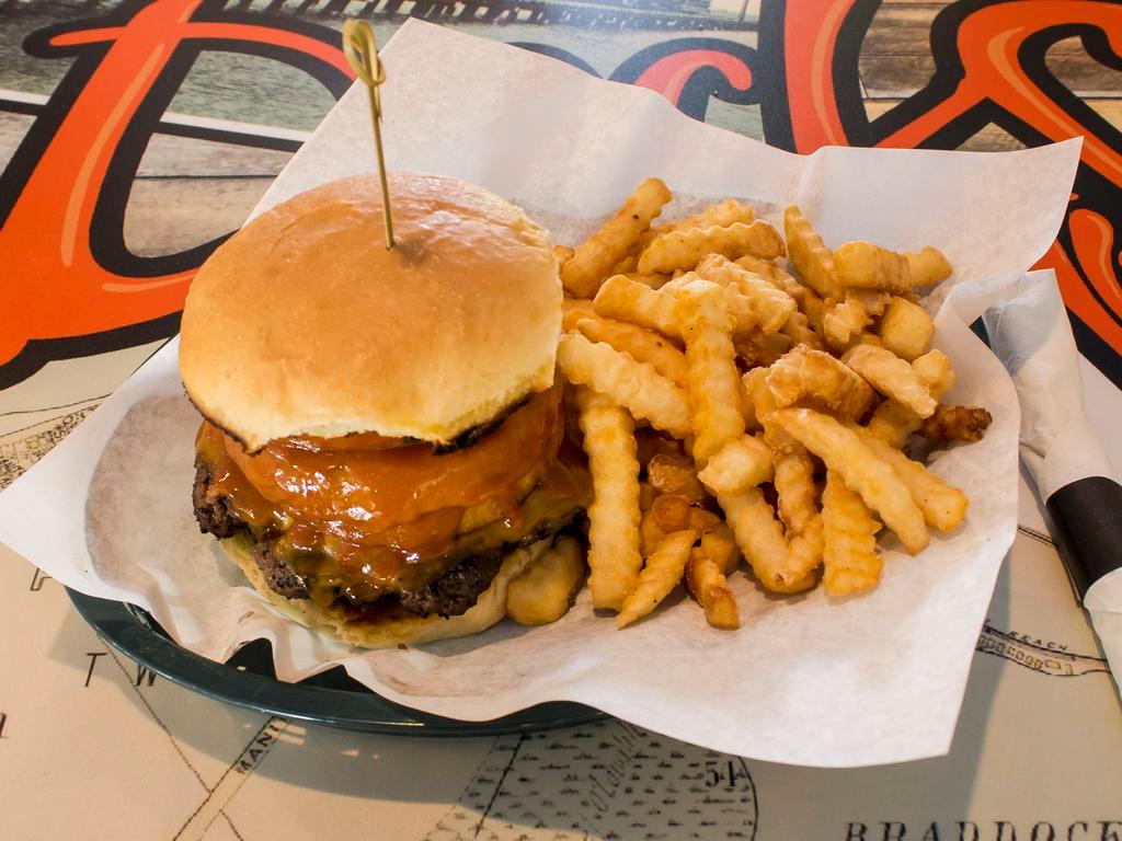 The Howdy Doody Burger · Topped with bacon, cheddar cheese, onion rings and golden BBQ sauce.