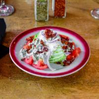 Wedge Salad · Crisp iceberg lettuce. Served with tomatoes, bacon, red onion, homemade creamy blue cheese a...