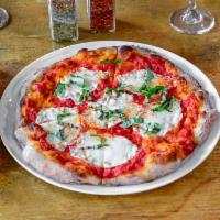 Traditional Margherita Pizza · Pomodoro sauce topped with fresh mozzarella and basil.