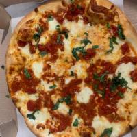 Margherita Pizza · Plum tomato sauce, fresh mozzarella, fresh basil and Romano cheese.