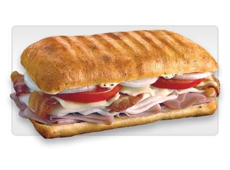 Sicilian Sub · Slow-cured ham, prosciuttini, pepperoni, provolone, sweet peppers and creamy Italian dressing. Served on freshly baked bread. 