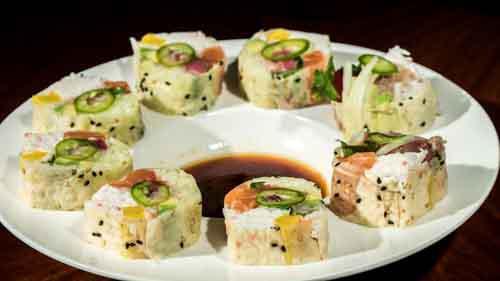 C1. Ceviche Roll · California roll with salmon, tuna, yellowtail, shrimp and yellow pickles wrapped in soy paper. Garnished with cilantro, onion and jalapeno.