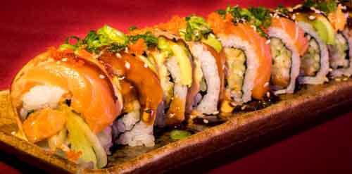 C7. Salmon Mania Roll · Spicy salmon roll topped with salmon, avocado and masago. Garnished with spicy mayo, eel sauce and creamy sesame dressing.