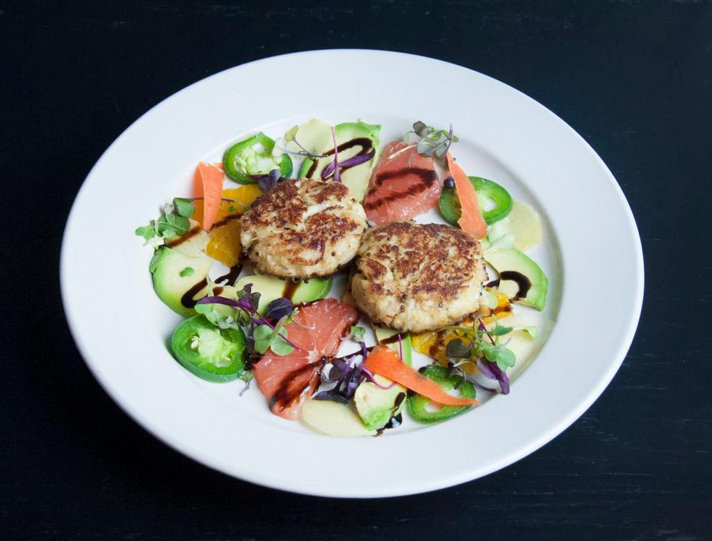 Crab Cake Dinner · Pan seared fresh jumbo lump crab cake served over a salad of avocado fresh ginger pink grapefruit, balsamic reduction and a drizzle of maple syrup.