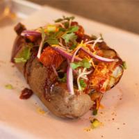 BBQ Chicken Tater · Huge Tater loaded with Crispy Chicken, BBQ Sauce, Cilantro, Cheddar Cheese, Tater Butter and...