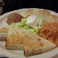 Quesadilla · Crispy flour tortilla stuffed with cheddar and Monterrey Jack cheeses and your choice of chi...