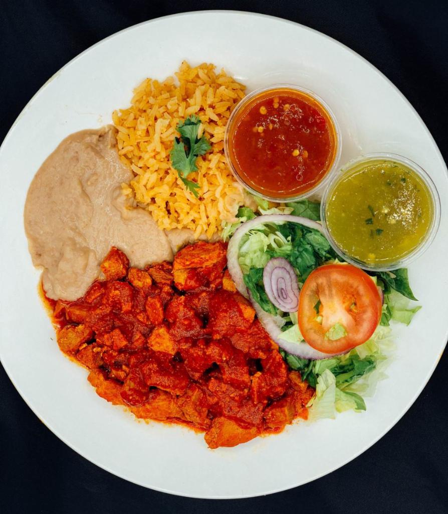 Asado de Puerco Plate · All plates served with salad, rice, beans, corn or flour tortilla and green or red chili sauce.