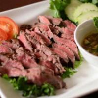 Steak and Thuc Pra-Hok · Grilled and sliced served with house special pra-hok sauce. (Pra-hok is fermented thick fish...