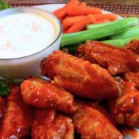 Chicken Wings · Marinated chicken wings cooked with olive oil, cloves garlic, chili powder, garlic powder, b...