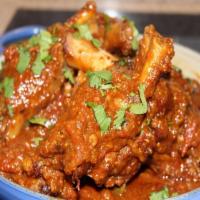 Madras Chicken Curry · Chicken thigh cooked with olive oil, cloves, cardamom pod, onion, green peppers, and coconut...