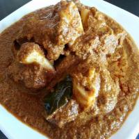 Goat Curry · Goat meat cut into pieces cooked with whole cloves, cardamom, onions, ginger, garlic and but...