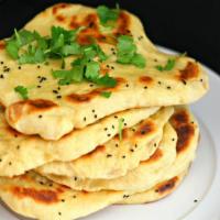 Garlic Naan · Bread flour delicately baked in clay pit topped with fresh garlic, butter, coriander, and ba...