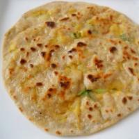 Potato Paratha · Unleavened layered wheat flour stuffed with potatoes, onions, and fresh spices.