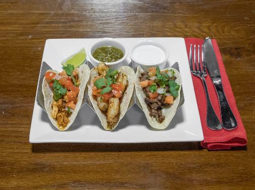 Create Your Taco Trio · Folded tortilla with a variety of fillings such as meat or beans. 