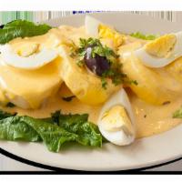 Papa a la Huancaina · Sliced baked potato covered in a spicy creamy cheese sauce.