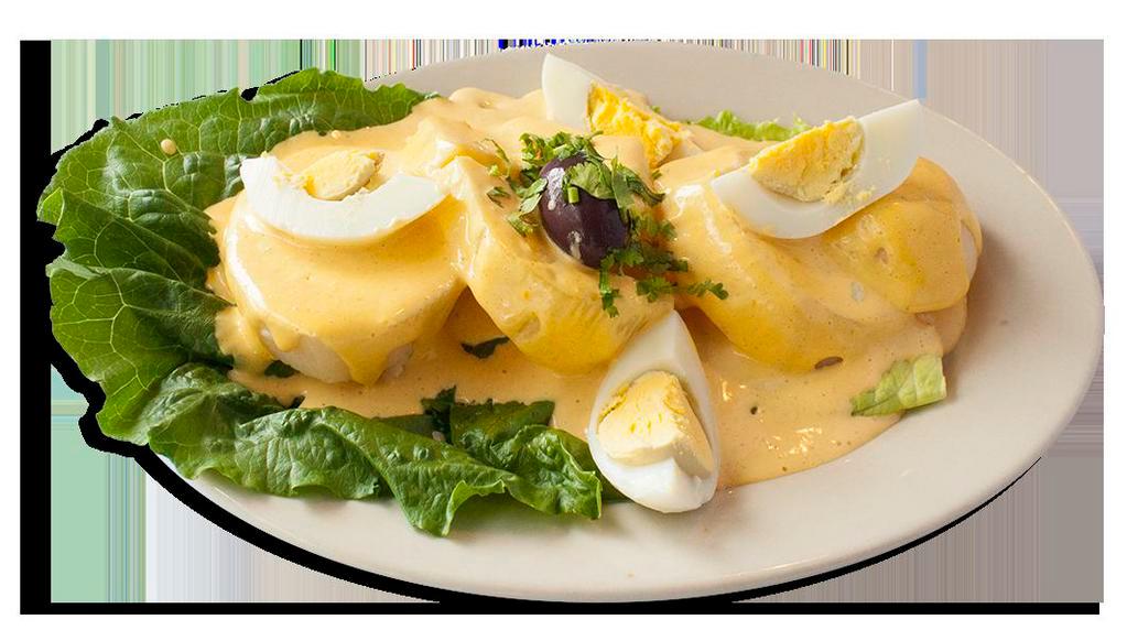 Papa a la Huancaina · Sliced baked potato covered in a spicy creamy cheese sauce.