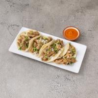 Carnitas Tacos · Dark beer and coca cola marinated roasted Berkshire pork butt topped with onions, cilantro a...