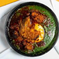 Tuo Zafi · Green soup topped witha fried red stew. It comes with tripe, goatmeat, fried fish. The tuo z...