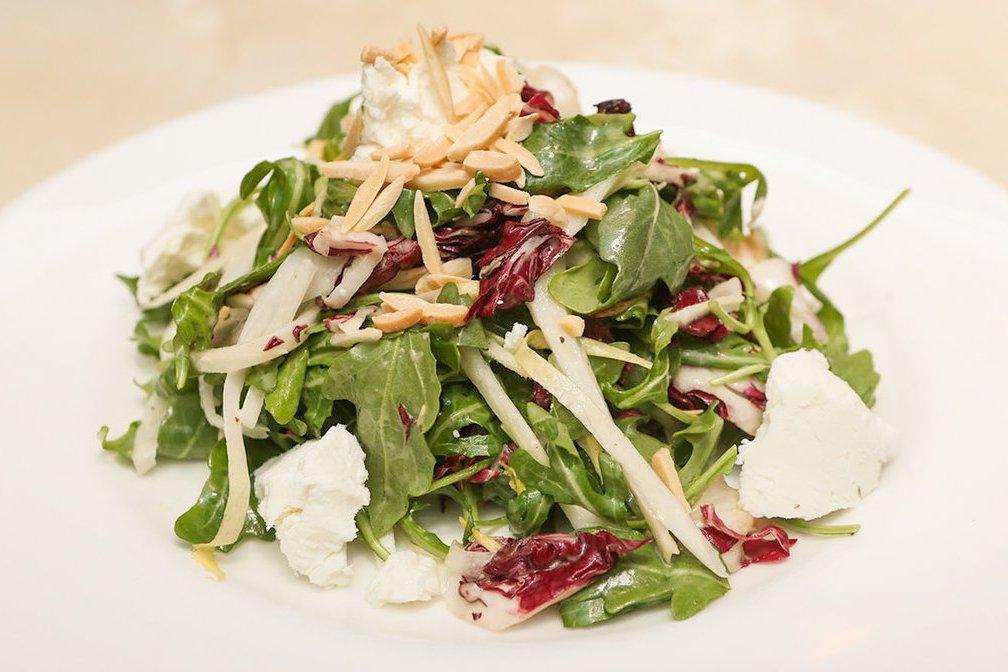 Tricolore Salad · Arugula, endive, and radicchio with goat cheese, toasted almonds, and honey mustard dressing.