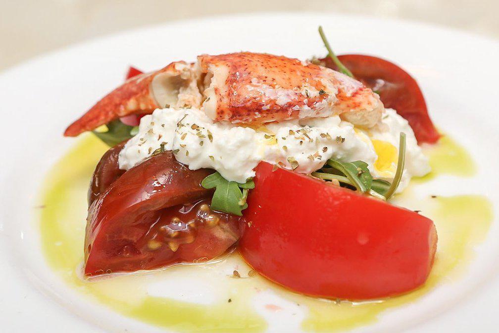 Lobster and Burrata Salad · Warm lobster tail, seasonal tomatoes, arugula, and burrata cheese