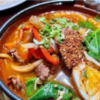 Beef Fire Ramen · House special ramen in a spicy broth with sliced steak and vegetables.