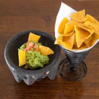Guacamole Tradicional · Jalapenos, cilantro, tomatoes, onions and lime juice, served with corn tortilla chips. Inclu...