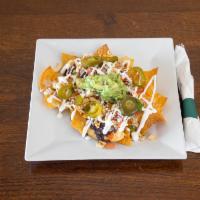 Nachos · Corn tortilla chips, black beans, cheese, pico de gallo, sour cream, pickled jalapenos, guac...