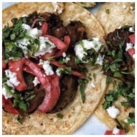 Steak Taco · Served with pickled onions, fresh cheese, black beans and sour cream. $4 each