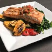 Salmon a la Parrilla · Grilled salmon with grilled vegetables, sauteed spinach and pico de gallo.