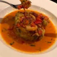 Mofongo · Mashed plantains in garlic and lobster sauce, red peppers, shrimp, cilantro and bacon.