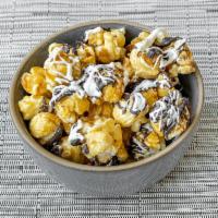 Black Tie Popcorn · Caramel popcorn drizzled with rich dark chocolate and white chocolate for an elegant black a...