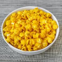 Spicy Queso Popcorn · The warm spiciness of cayenne on rich cheddar cheese popcorn makes this a popular flavor.