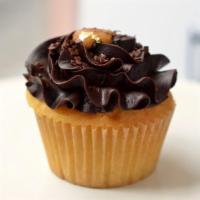 Vanilla Extrovert Cupcake · She's an exhibitionist! Vanilla cake with dulce de leche filling, chocolate icing, and Frenc...