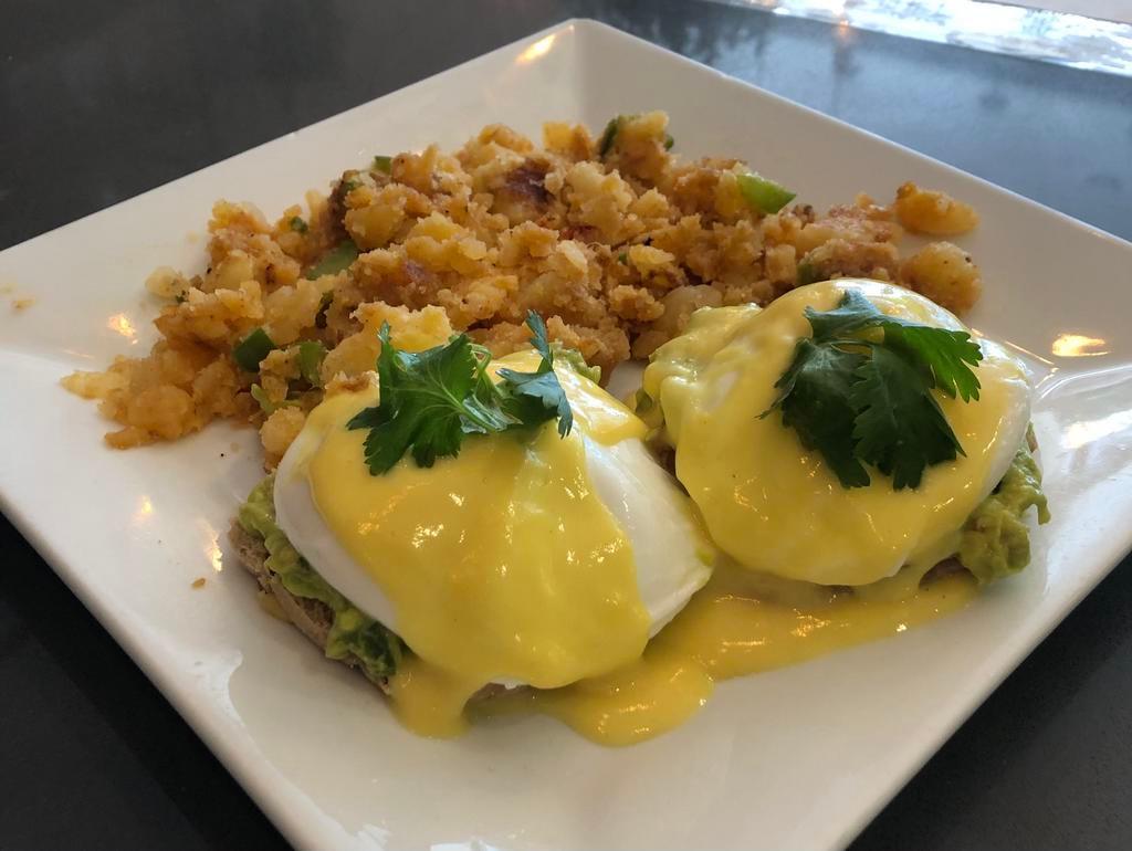 Guacamole Benedict · 2 poached eggs, guacamole and Hollandaise sauce on multi-grain English muffin served with home fries