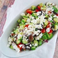 Greek Salad · Iceberg lettuce, tomatoes, cucumbers, peppers, onions, feta, Kalamata olives and grape leave...