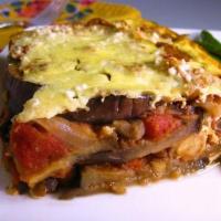 Mousaka Plate · Layered eggplant, zucchini, and potato with seasoned meat filling topped with a creamy becha...