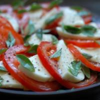 Mozzarella and Tomato · Fresh mozzarella paired with sliced tomatoes, fresh basil and olive oil.