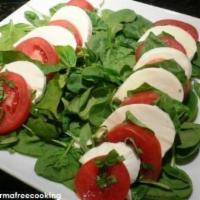 Caprese Salad · Fresh mozzarella, juicy sliced tomatoes and fresh basil with olive oil. Served over mixed gr...