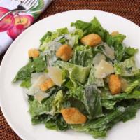 Caesar Salad · Hearts of romaine, homemade seasoned croutons and Caesar dressing. Sprinkled with grated Par...