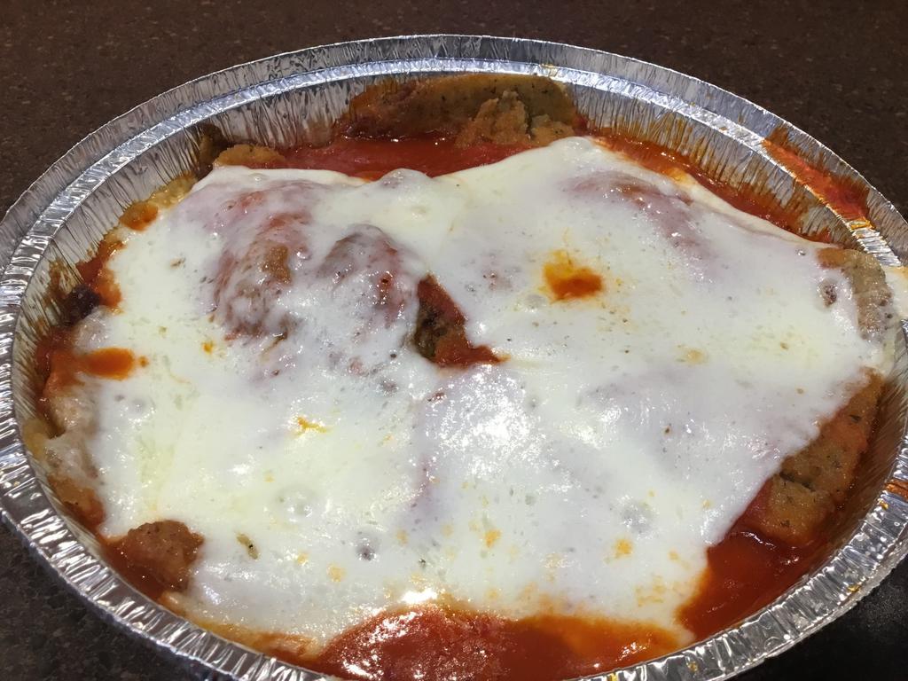 Eggplant Parmigiana · Breaded and fried eggplant topped with marinara sauce and mozzarella cheese, then baked.