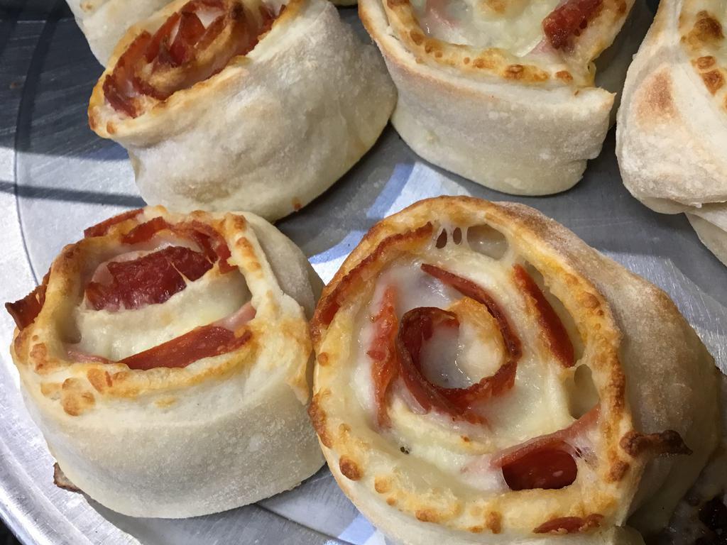 Pepperoni Pinwheel · Homemade pizza dough and pepperoni rolled up, then sliced into thick pieces. Baked golden brown.