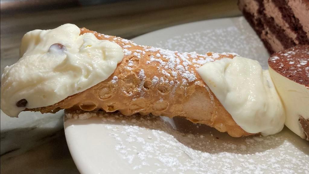 Cannoli · Light Italian pastry shell stuffed with sweet ricotta and chocolate chips. Sprinkled with powdered sugar.